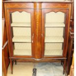 An Edwardian mahogany display cabinet, the frieze with inlaid decoration, fitted with two glazed
