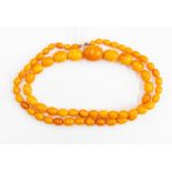 An amber type bead necklace, comprising graduated beads the largest approx. 22 x 15mm the largest