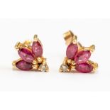 A pair of ruby and diamond 9ct gold stud earrings, comprising a fan of three marquise cut rubies,