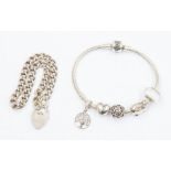 A silver Pandora charm bracelet, complete with various charms including an open heart bead charm ,