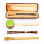 A 9ct gold capped pipe with original box, a miniature green enamelled silver pill box, a