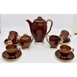 A Carlton Ware rouge Royale coffee set comprising coffee pot, milk jug, sugar bowl, four cups and