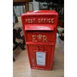 A reproduction 'ER' cast iron post box, in red livery with gilt detail, with two brass keys, 56cm