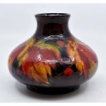 A Moorcroft Flambe 'Leaf and Berry' pattern bulbous shaped squat vase, early 20th Century, tube