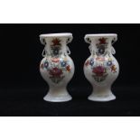 A pair of Central European enamelled milk glass vases, 18th/19th Century, of baluster form with twin