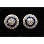 A pair of Art Deco style diamond and sapphire platinum target studs, central diamond combined weight