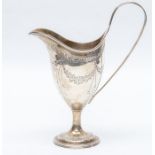 A George III silver helmet shaped cream jug, the body bright-cut engraved with swag tied floral