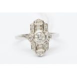 An Art Deco style diamond and platinum ring, the centre set with a round brilliant cut diamond,