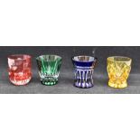 A Faberge set of four flash cut glass tot glasses, in red, yellow, green and blue, each measuring