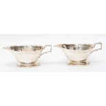 A pair of Art Deco plain silver sauceboats, geometrics style cut border, square style handles on