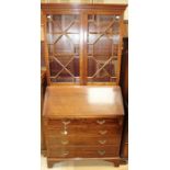 An Edwardian mahogany bureau bookcase, the upper section with two glazed doors, the fall front