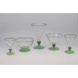 A suite of French art deco drinking glasses, circa 1930, the conical bowls with silvered knop