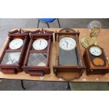 Six various clocks comprising an Edwardian mahogany and satinwood inlaid eight day mantle clock,
