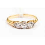 An 18ct gold and diamond set ring, set with three graduated  brilliant cut diamonds with a total