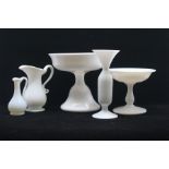 An assembled group of Central European milk glass, 19th Century, including a pair of bottle vases,