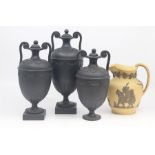 A set of three basalt vases and covers, possibly Wegwood, of amphora shape with twin scroll or '