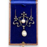 An Art Nouveau style diamond set pearl necklace, open work swirls suspended from gilt metal chain,