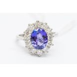 A tanzanite and diamond platinum ring, central oval cut tanzanite weighing approx. 2.52carats,