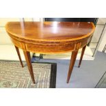 A George III mahogany and satinwood demilune tea table, having a fold over top, 73cm high, 98cm