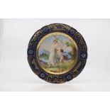 A Vienna-style cabinet plate, of slightly lobed shape and painted with a scene of Elenora and Genius