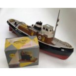 A battery operated tug, remote controlled boat, along with Mamod boxed steam engine
