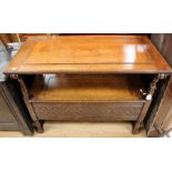 A mid 20th Century oak Monks bench, in the Jacobean style, having a lidded seat revealing storage