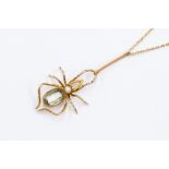 An Edwardian spider pendant, the body set with an oval aquamarine, pearl set head, length of the