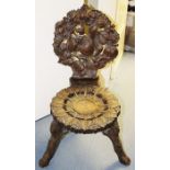 A late 19th Century Black Forest carved oak hall chair, elaborately carved throughout to back, the
