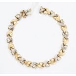 A 14ct gold continental yellow and white gold heart link bracelet, length approx. 20.5cm, box clasp,