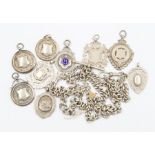 A collection of silver jewellery to include two Albert watch chains, along with nine medallion fobs,