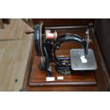 A Wilcox and Gibbs hand powered sewing machine, probably late 19th Century, the cast iron frame