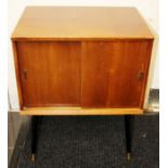 A 1950s small cabinet, fitted with two sliding doors