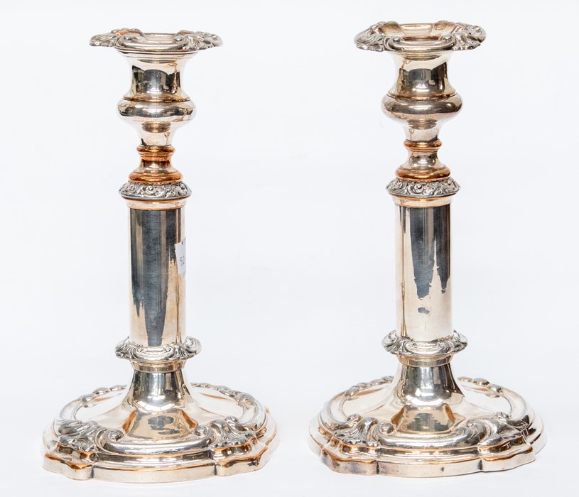 A pair of late 19th Century Sheffield Plate telescopic candlesticks, stamped on foot rim with