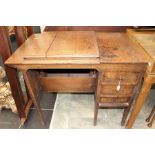 A circa 1930/40's oak privacy desk with lift out hood for working space an three side drawers