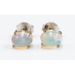 A pair of Ethiopian opal and silver studs, comprising oval cut opals with green and pink play of