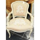 A French style Louis XV style cream painted open armchair, having a woolwork back and a woolwork