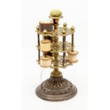 A Victorian cast iron and brass bobbin stand, the central knopped stem supporting three openwork