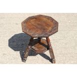 A 19th Century oak two-tier nonagonal topped occasional table, each tier carved with lunettes,