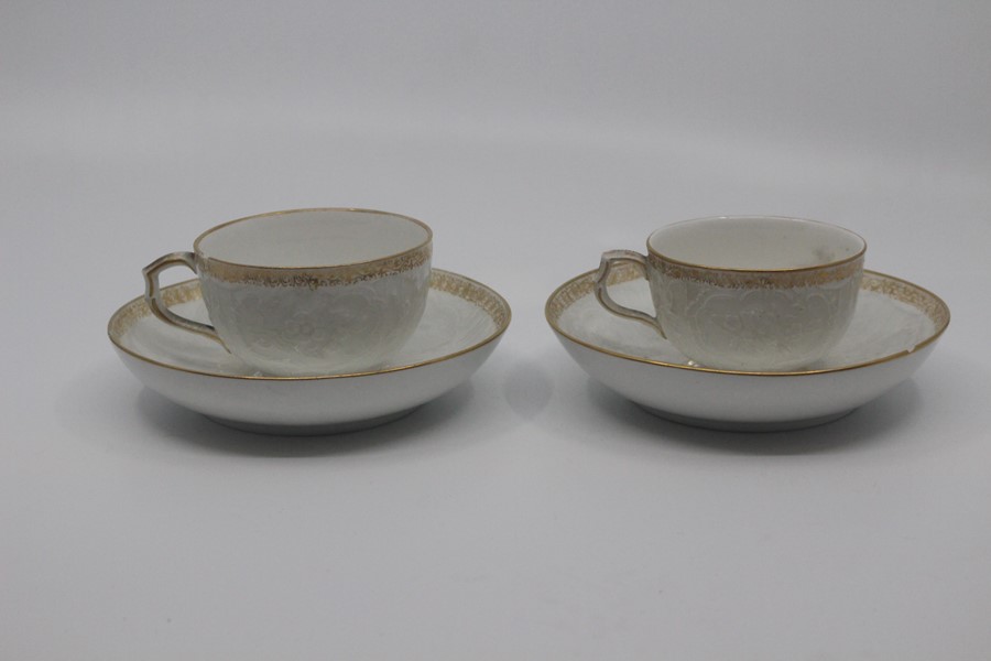 A pair of Berlin porcelain coffee cups and saucers, circa 1890, of rounded form and finely moulded