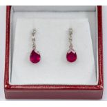 A pair of ruby and diamond drop earrings, comprising pear cut rubies claw set, approx. 4 x 6mm,