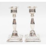 A pair of Edwardian silver candlesticks, filled by Mappin & Webb, Birmingham, 1910, 13.5 cm high,