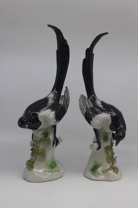 A pair of German porcelain figures of magpies, early 20th Century, modelled after Meissen with