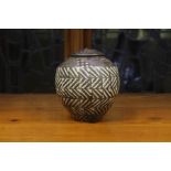 A John Wheeldon lustre jar and cover, of ovoid form with canted shoulder and slightly domed cover,
