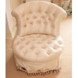 A Victorian white button back upholstered walnut framed salon chair, circa 1870.