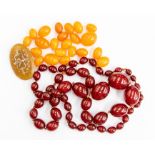 A cherry amber type bead necklace, comprising graduated beads the largest approx. 22 x 30mm the