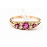 A ruby and diamond 9ct gold ring, set with three round rubies inter-spaced with double diamond