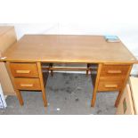 A circa 1950's oak writing desk, with two drawers either side, 76cm high, 137cm wide, 76cm deep
