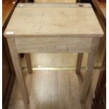 A late 19th / early 20th Century pine school desk, having a single hinged lid enclosing storage