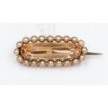 An Edwardian imperial topaz and seed pearl brooch, the lozenge topaz approx. 19mm x 5mm, claw set