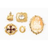 A Victorian garnet set gilt metal brooch, scroll and foliate engraved details, set with five oval
